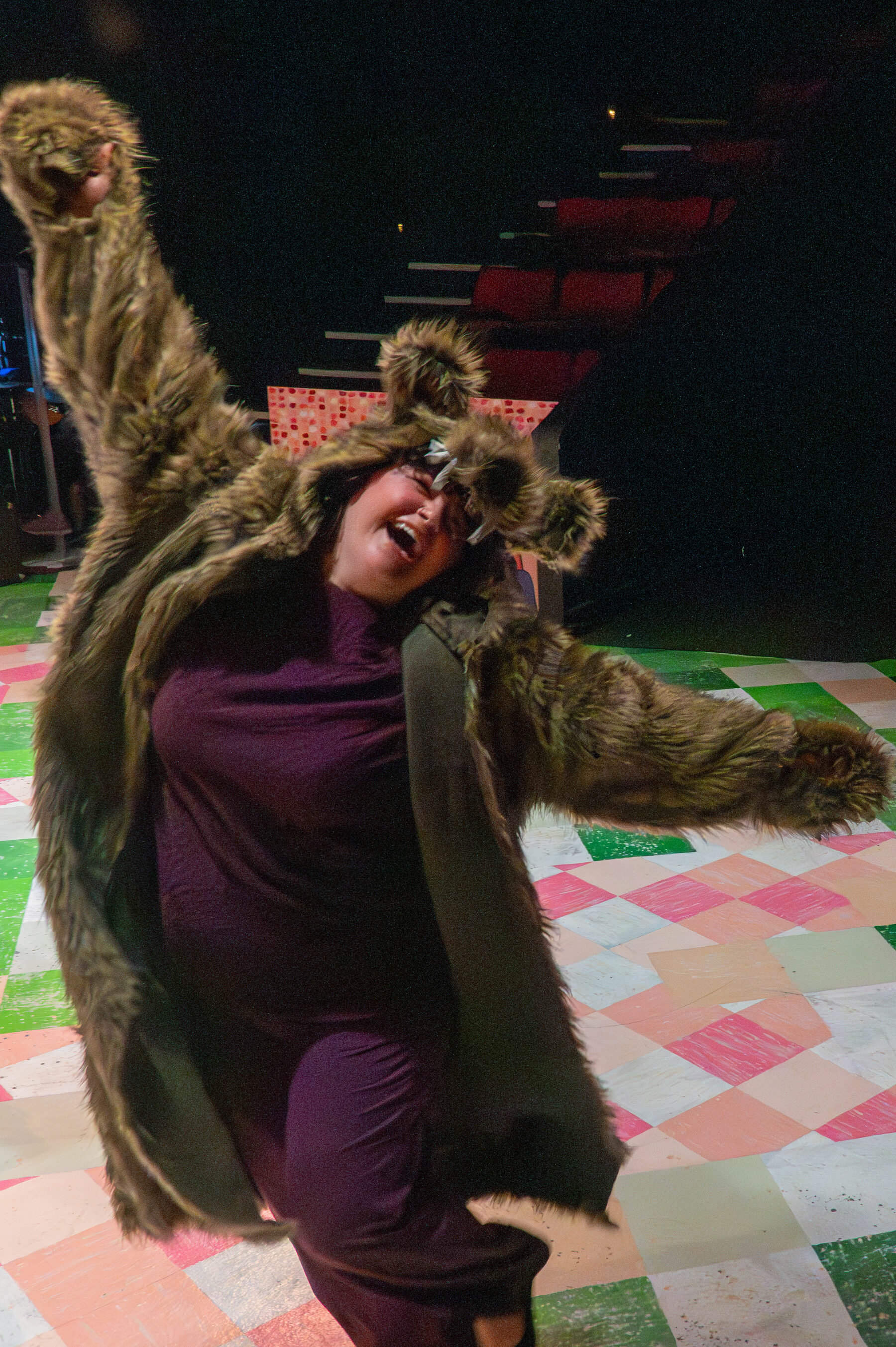 The bear character mid-dance, wild and ecstatic