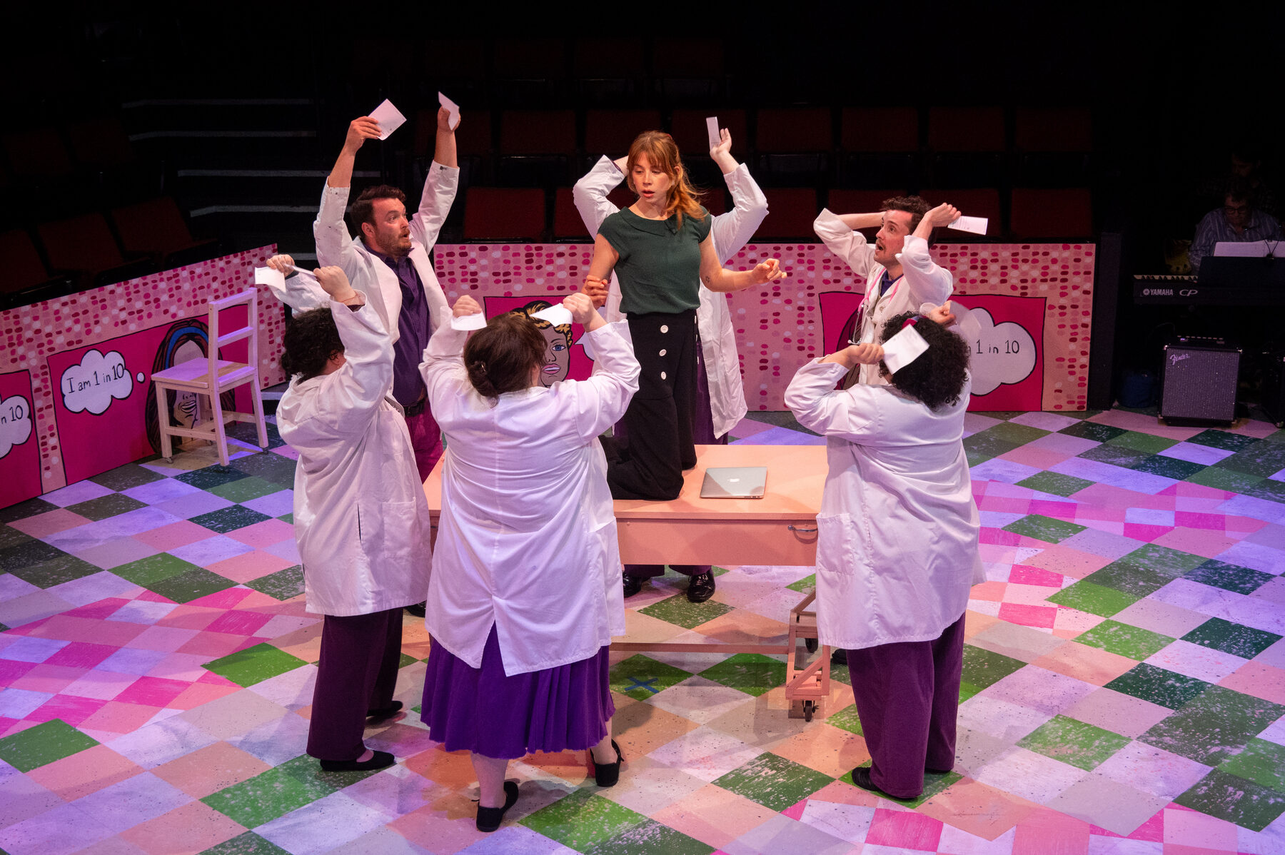 Dancing doctors in white coats circle the lead character