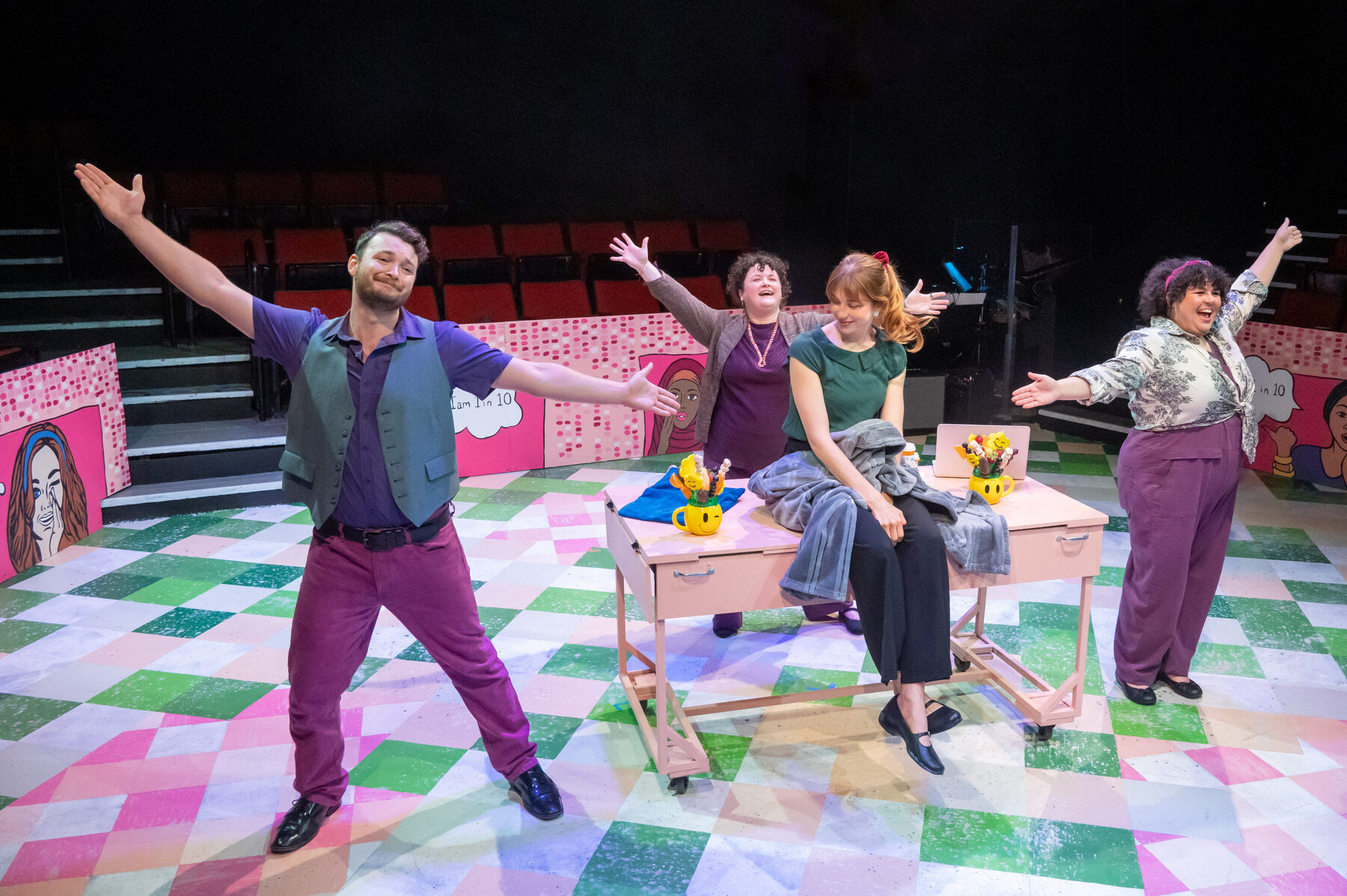 Full ensemble in showtime pose with arms outstretched