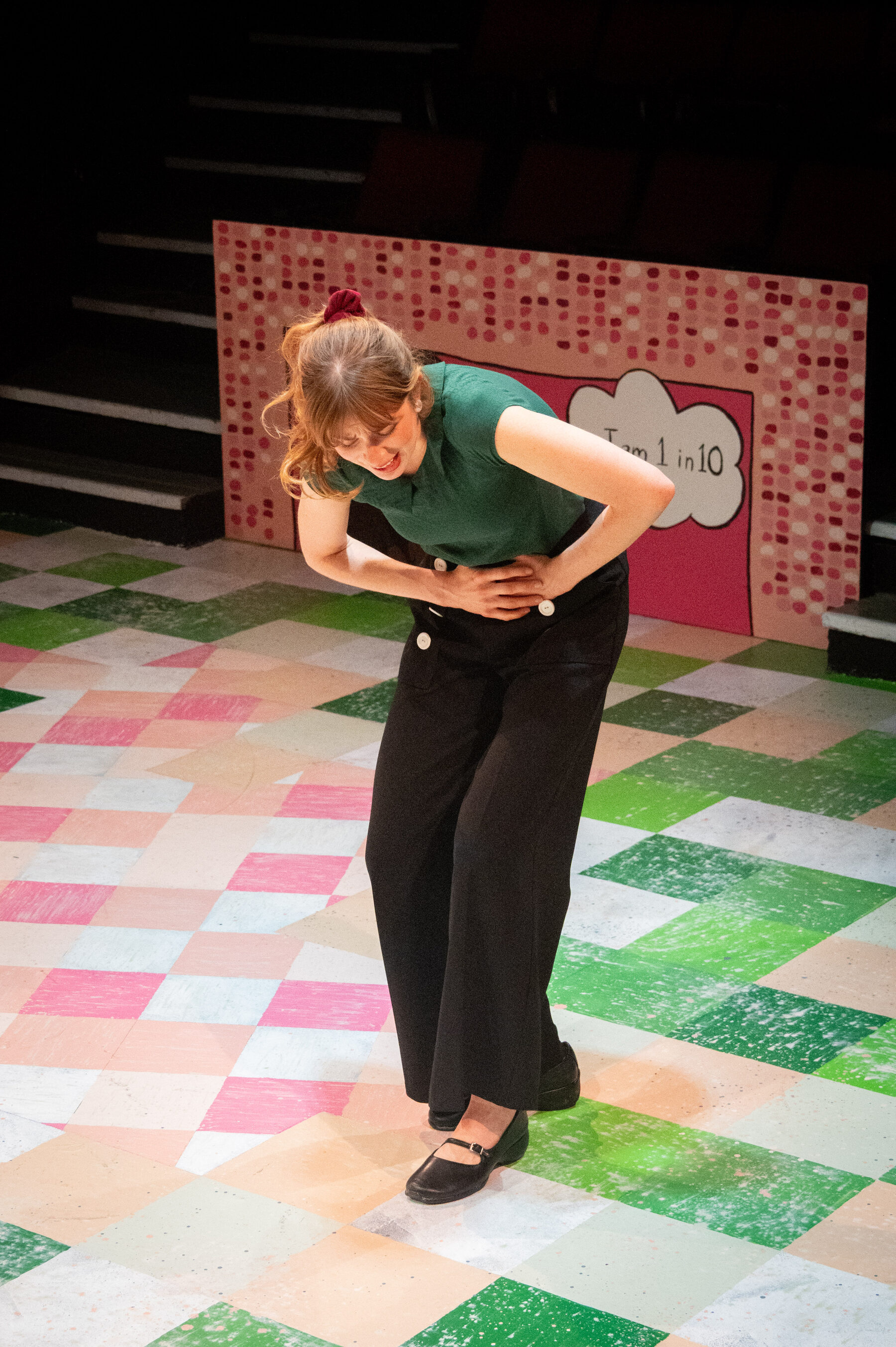 The lead doubled over in pain on the checkered stage