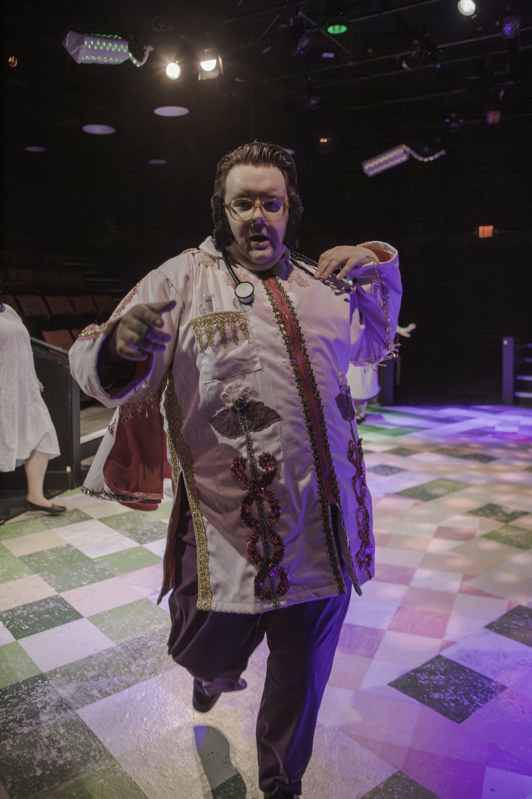 Sequined doctor character in full theatrical pose
